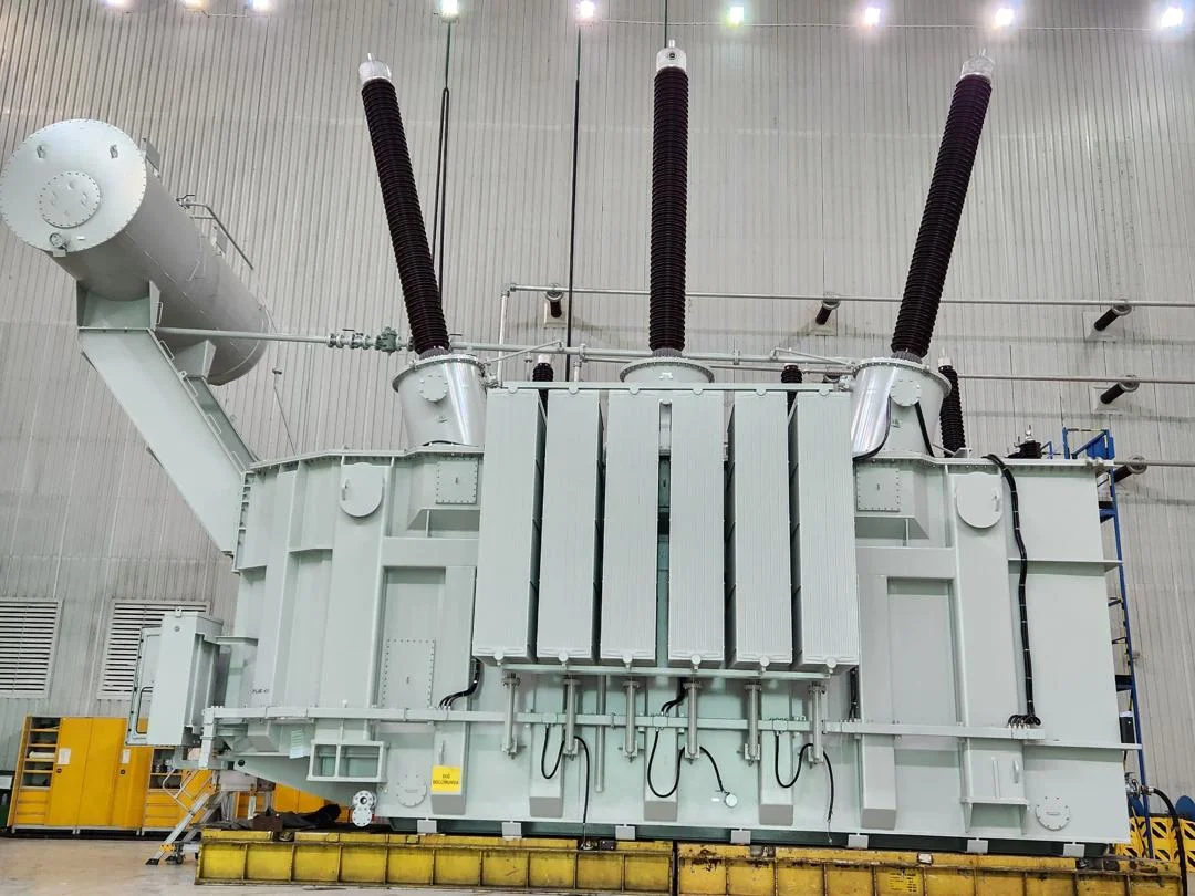 Large-scale power transformer unit inside industrial testing bay
